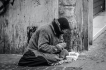 Grayscale-photography-of-man-praying-on-sidewalk-with-food-1058068-1024x682.jpg