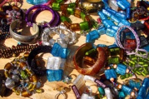 Trinkets-wooden-table-colorful-costume-jewelry-sunshine-70900190.jpg