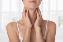 A-woman-with-thyroid-issues-holds-her-neck..jpg