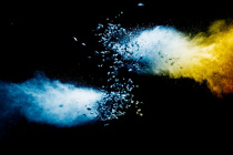 Split-debris-of-stone-exploding-with-blue-powder-against-black-background 36326-3559.jpg