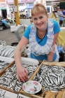 32881-a-woman-sells-fish-in-the-market-privoz-july-5-2012.jpg